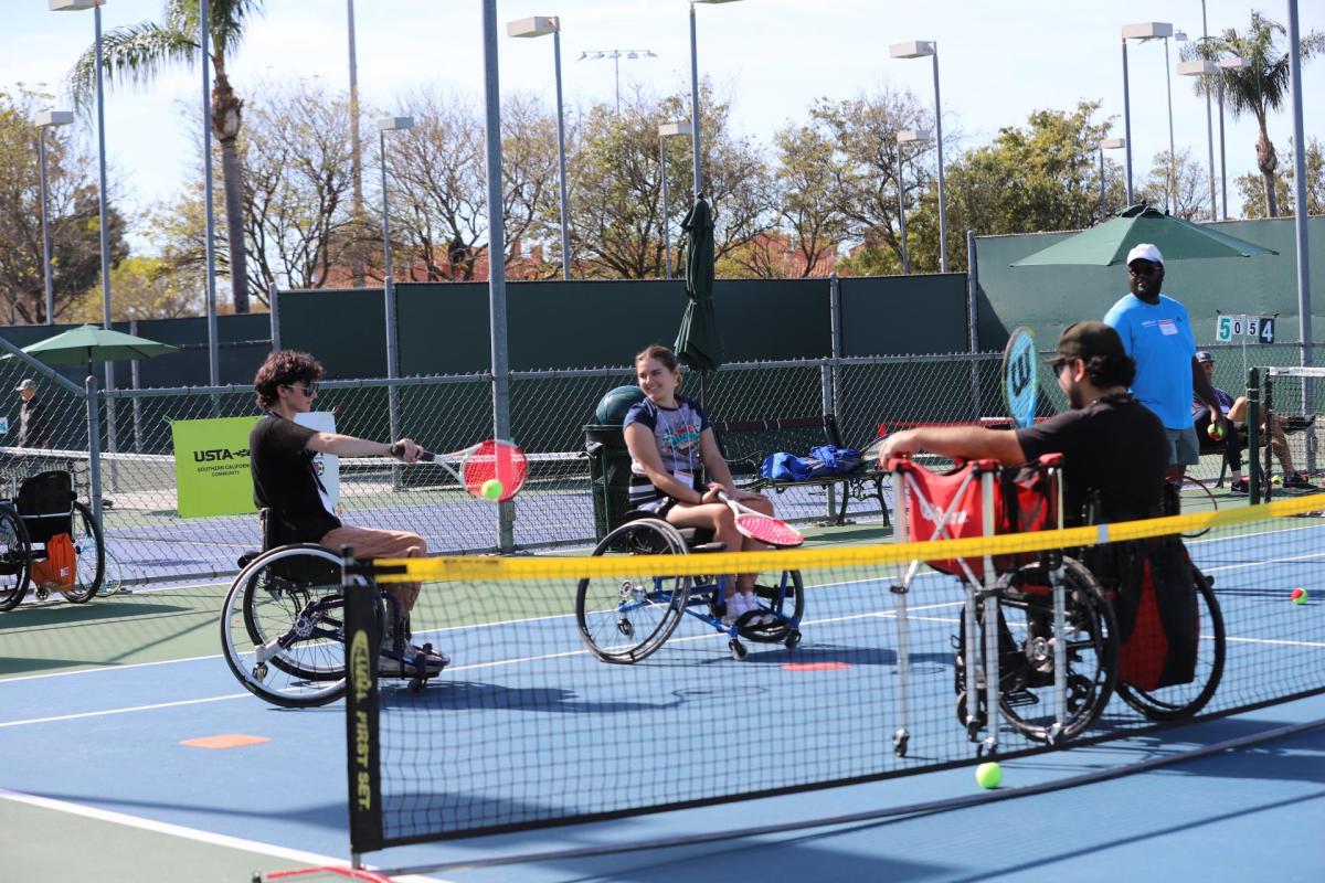 Athletes playing adaptive tennis. Photo courtesy of Burbank. Individuals in wheelchairs play tennis
