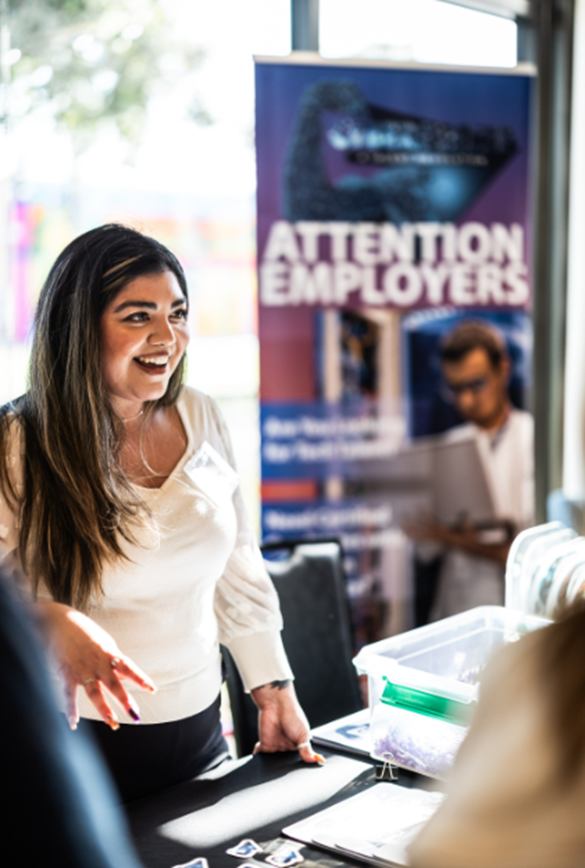 Cyber Proud Talent Manager Cecily Gomez shares information with employers at a local hiring event.