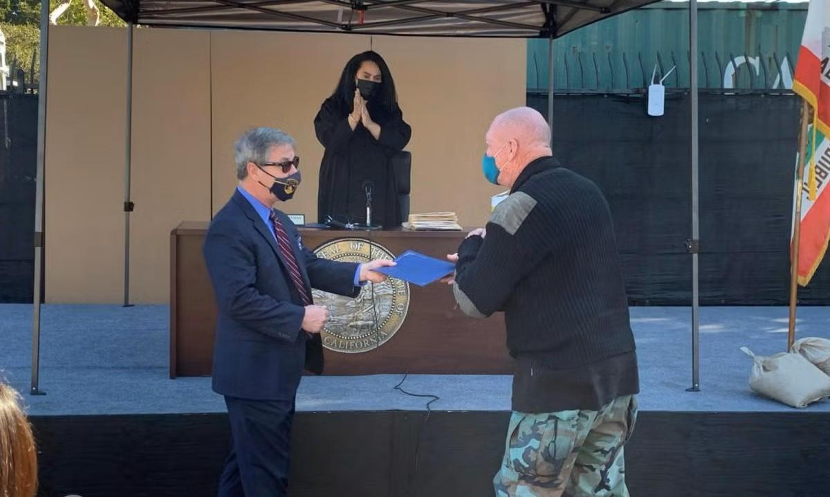Redondo Beach established an outdoor court in 2019 that dismisses nonviolent misdemeanors and connects unhoused residents with supportive services. Photo courtesy of Redondo Beach. Man receiving certificate before a judge
