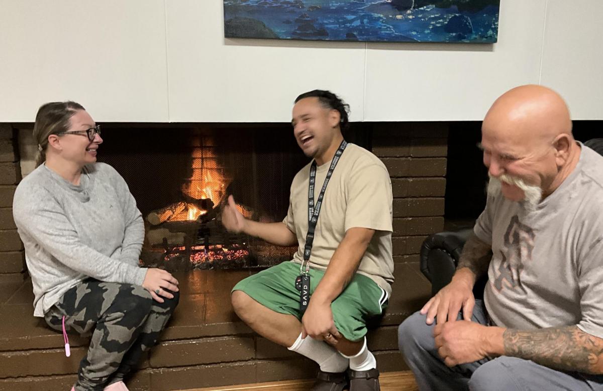 Guests gather by the fire at a local church that partners with the city of Campbell to provide hot meals, snacks, and essential items for residents experiencing homelessness. Photo courtesy of Campbell United Methodist Church.