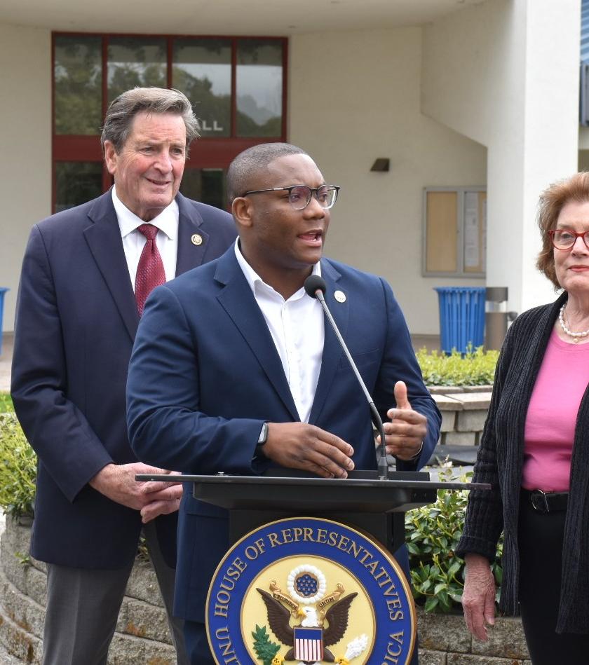 Alex Walker-Griffin speaking with leaders behind him