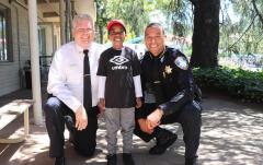 Piedmont Fire Chief Bret Black, left, and Police Chief Jeremy Bowers visit with a young resident as part of the town's community outreach to improve public safety.