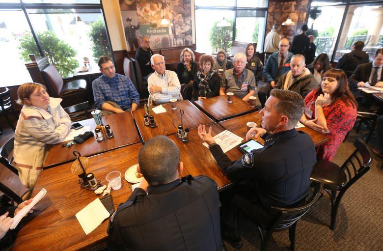 City of Redlands Police Chief Chris Catren sits with members of the community. 