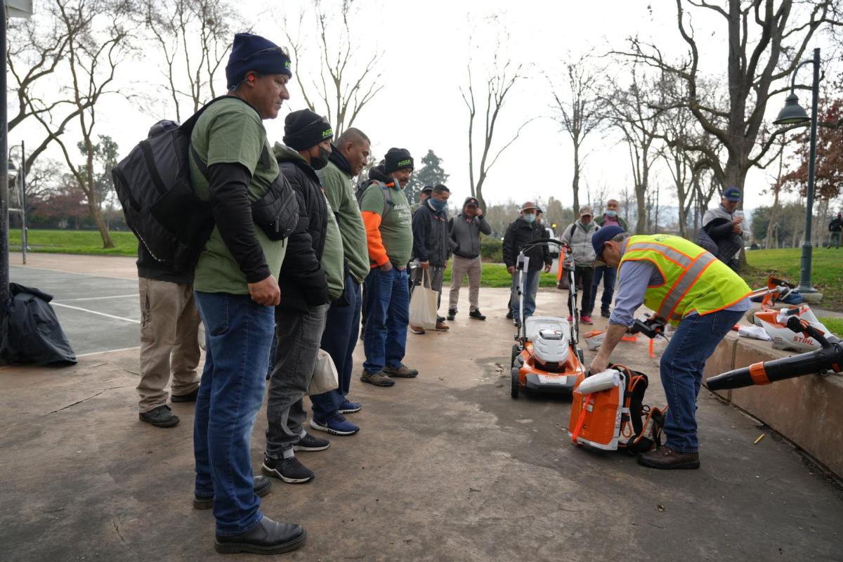 A trainer demonstrates zero-emission electric landscaping equipment to workers as part of Mountain View's tool lending library program. Photo courtesy of Mountain View.
