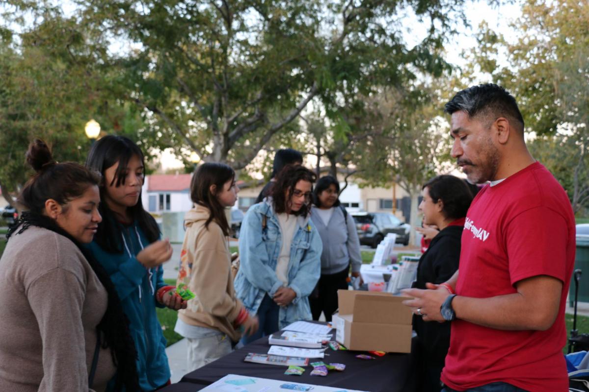 Residents visit an opioid prevention resource table during the Palmdale #FightFentanylAV campaign’s Red Ribbon Week kick-off event.