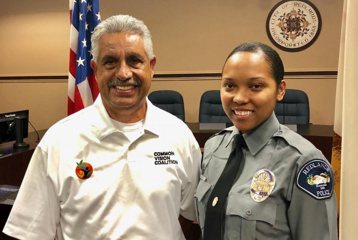 Mario Saucedo, founder of The Common Vision Coalition, poses with a member of the Redlands Police Department