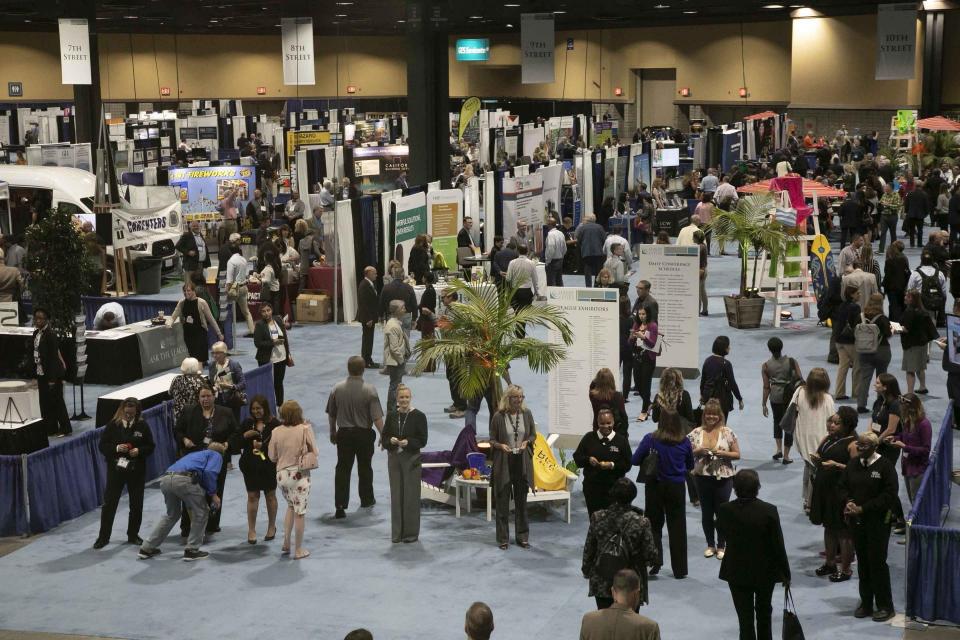 Attendees visit the expo hall.