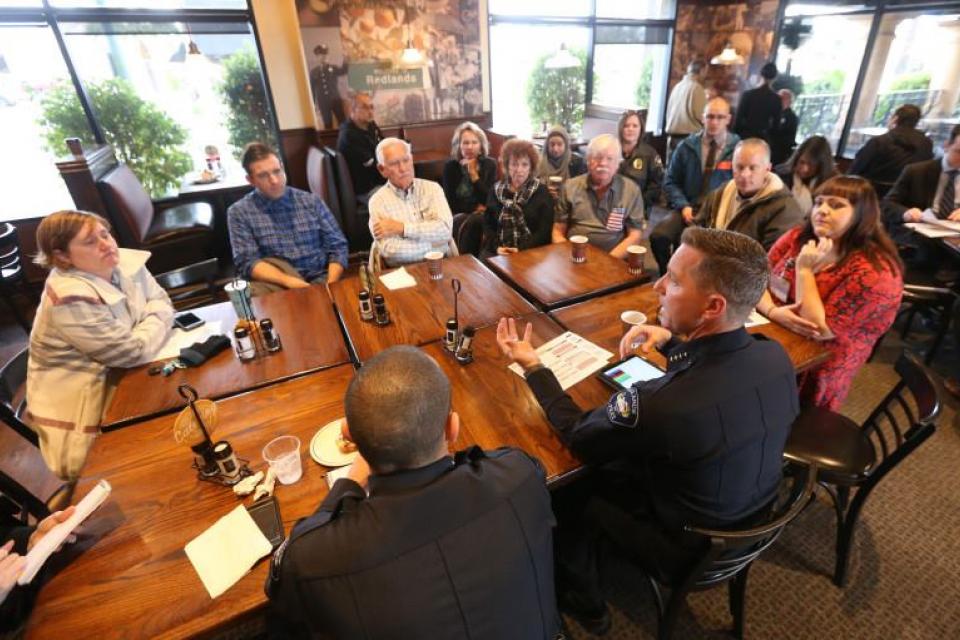 City of Redlands Police Chief Chris Catren sits with members of the community. 
