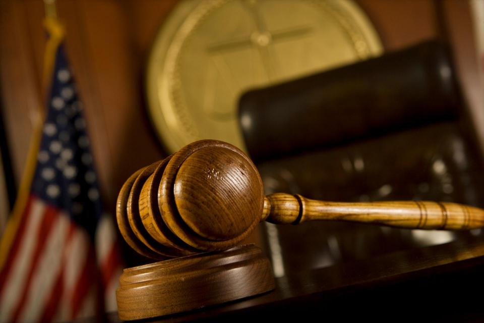 A judge's gavel sitting on a desk. 