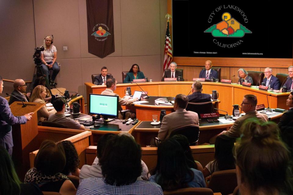 A group of residents watching a Lakewood city council meeting in person..