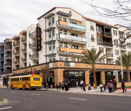 A 5-over-1 residential building with ground-floor commercial space. 