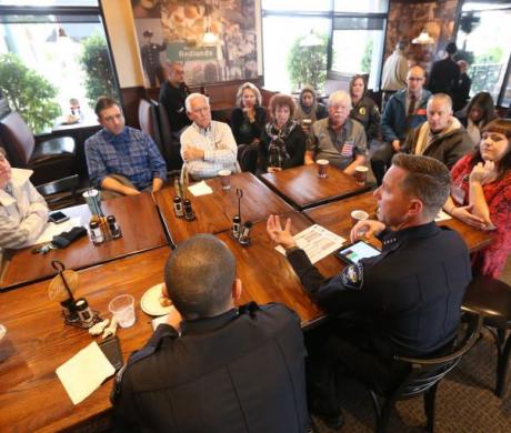 City of Redlands Police Chief Chris Catren sits with members of the community. 