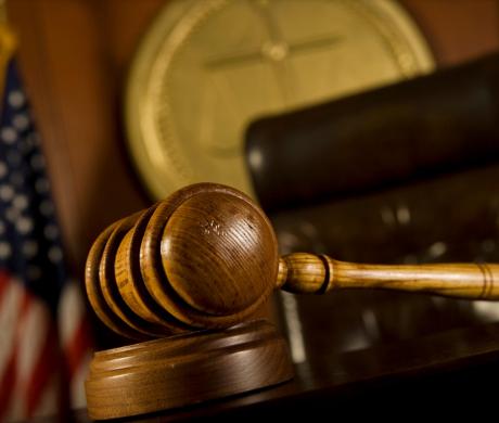 A judge's gavel sitting on a desk. 