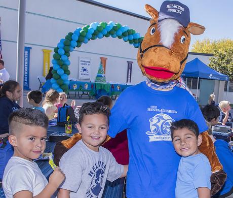 Santa Clarita mascot, Sammy Clarita, poses with children at a local event. 